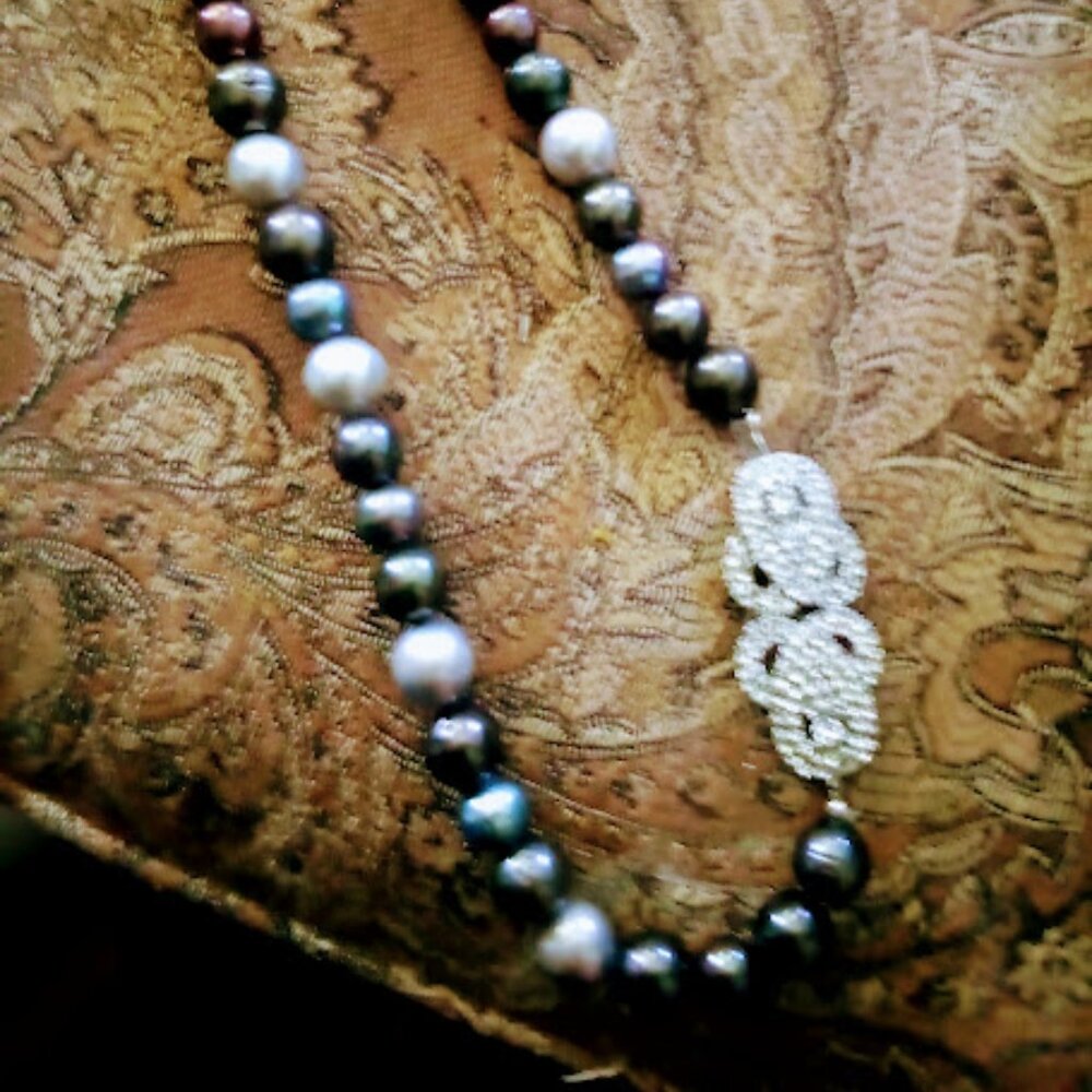 Heavy pearls irregular shapes. Not knotted. Rhinestone clasp